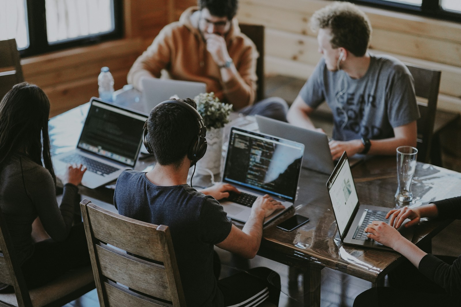A diverse professional team collaborating around technology.